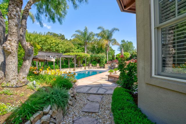 a view of a house with a yard and garden