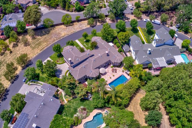 an aerial view of house with a yard and swimming pool