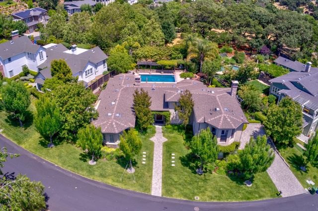 an aerial view of house with swimming pool outdoor seating and yard