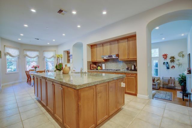 a kitchen with stainless steel appliances granite countertop a sink and cabinets