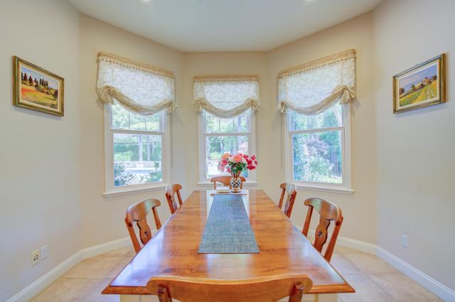a view of a dining room with furniture a chandelier and wooden floor