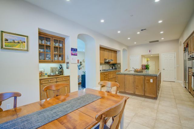 a kitchen with stainless steel appliances granite countertop a sink dishwasher stove and refrigerator