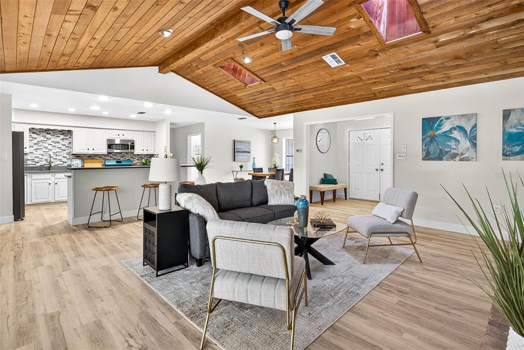 14252 Trinity Road Brooksville, FL 34614 - Photo 5 of 26 a living room with furniture and a wooden floor