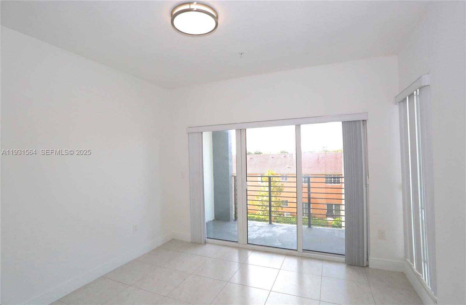 6151 Northwest 182nd Lane, Unit 301 Hialeah, FL 33015 - Photo 2 of 13 a view of an empty room with a window