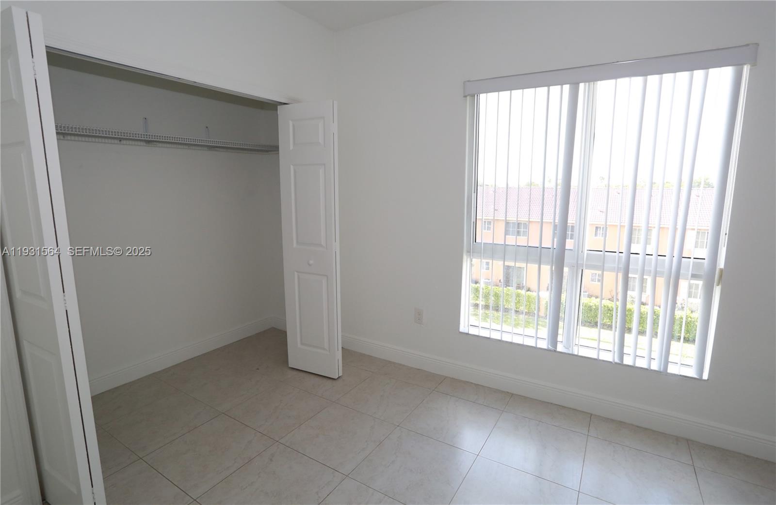 6151 Northwest 182nd Lane, Unit 301 Hialeah, FL 33015 - Photo 3 of 13 a view of an empty room with a window