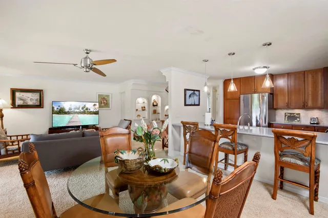 a dining room with furniture a window and kitchen view