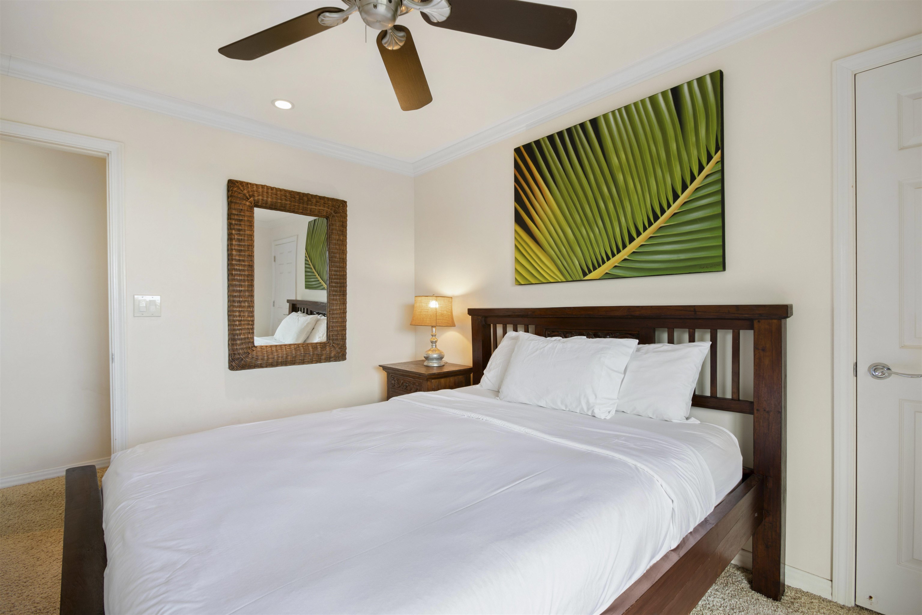150 Puukolii Road, Unit 41 Lahaina, HI 96761 - Photo 18 of 34 a bedroom with a bed and a painting on the wall