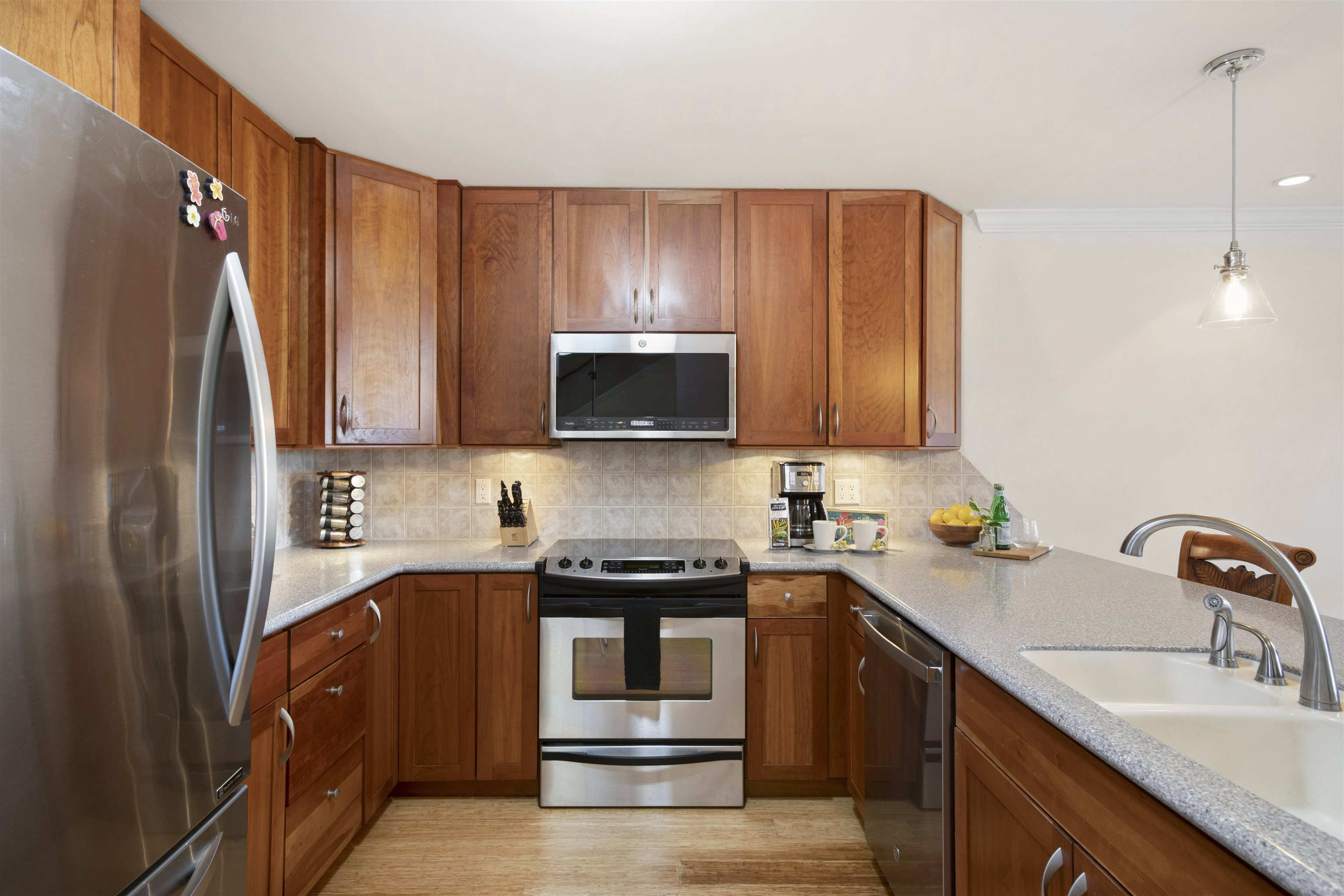150 Puukolii Road, Unit 41 Lahaina, HI 96761 - Photo 7 of 34 a kitchen with stainless steel appliances granite countertop a refrigerator and a sink