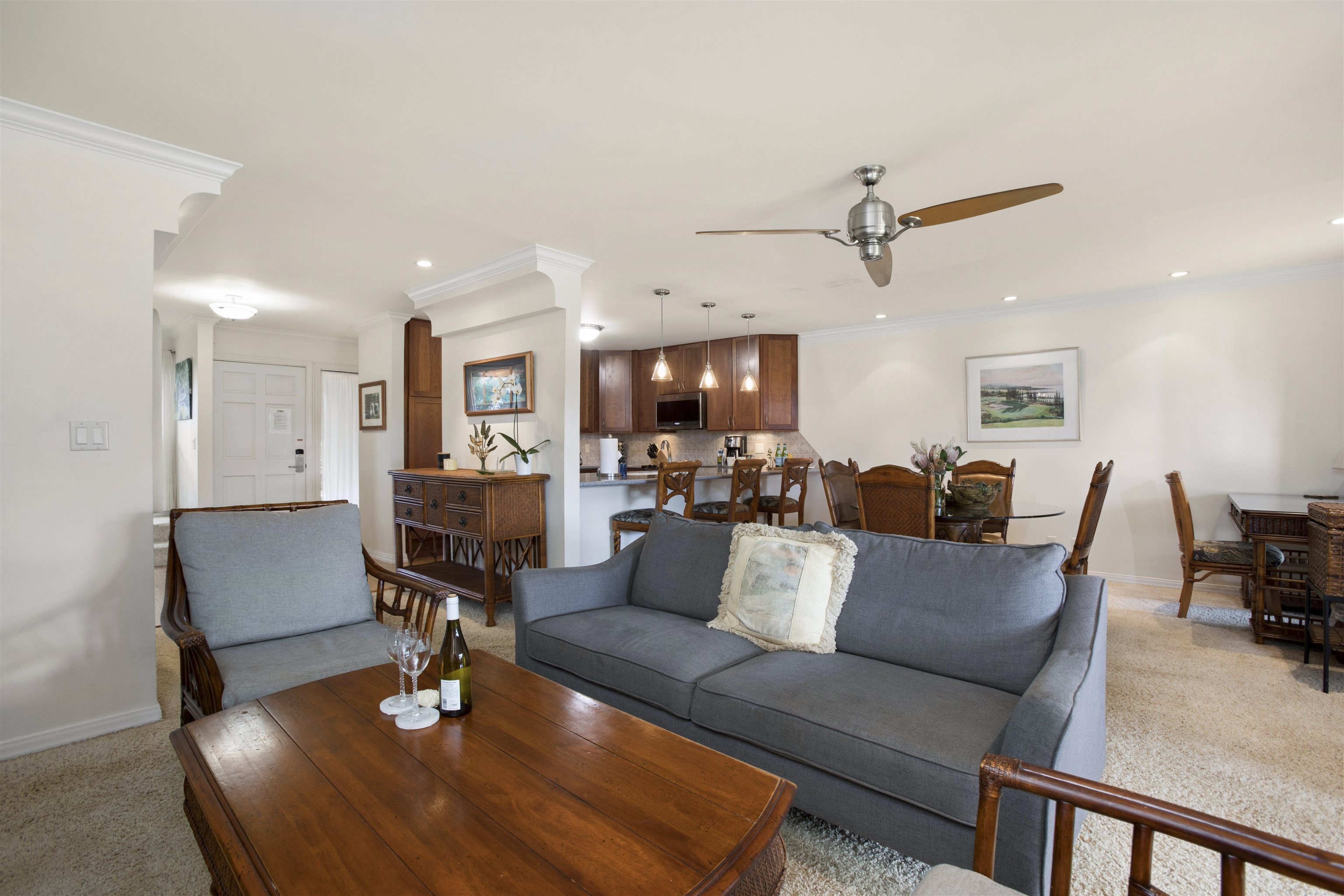 150 Puukolii Road, Unit 41 Lahaina, HI 96761 - Photo 10 of 34 a living room with furniture kitchen view and a chandelier