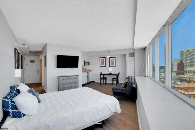 a kitchen with stainless steel appliances granite countertop a stove top oven a sink dishwasher and microwave with wooden floor