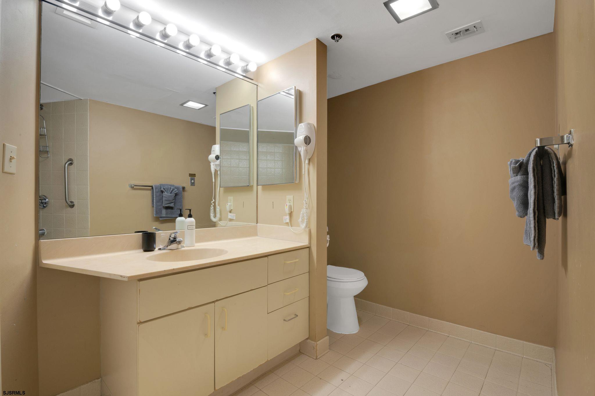 1515 Boardwalk, Unit 1004 Atlantic City, NJ 08401 - Photo 16 of 19 a bathroom with a sink toilet and shower