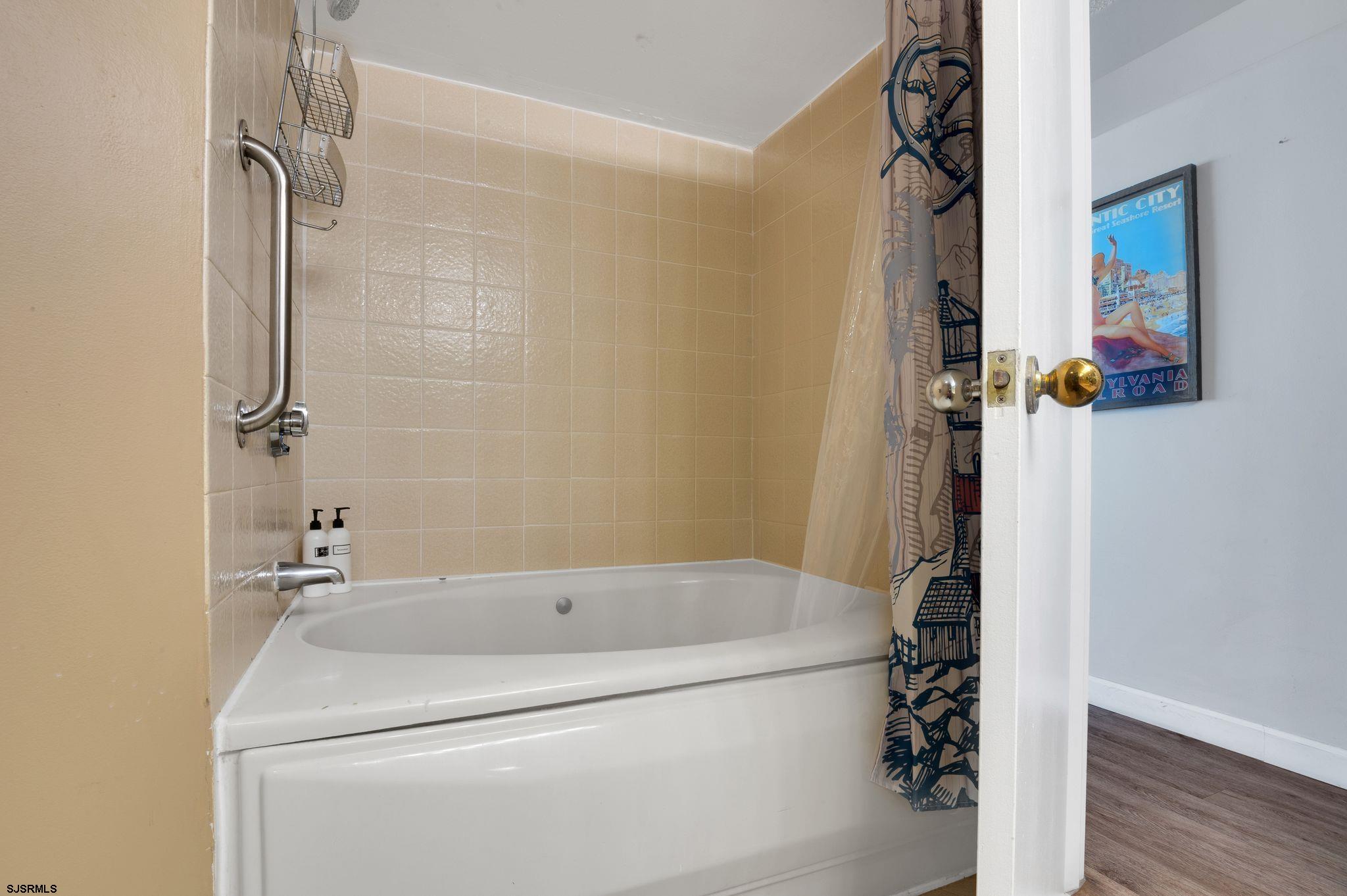 1515 Boardwalk, Unit 1004 Atlantic City, NJ 08401 - Photo 17 of 19 a bathroom with a bathtub and a shower