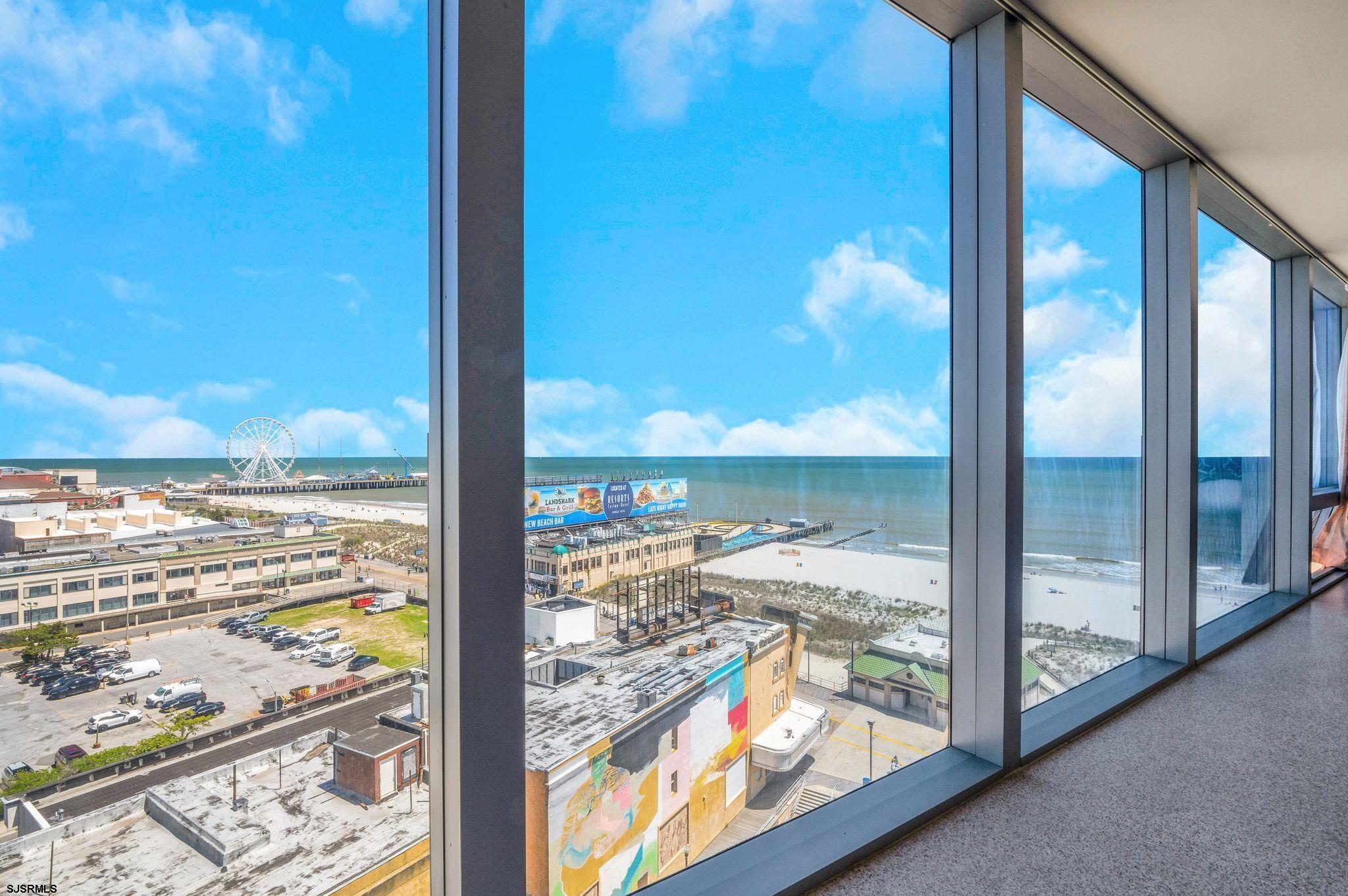 1515 Boardwalk, Unit 1004 Atlantic City, NJ 08401 - Photo 7 of 19 a view of a glass door with a floor to ceiling window next to a yard