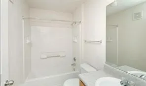 a bathroom with a toilet and shower