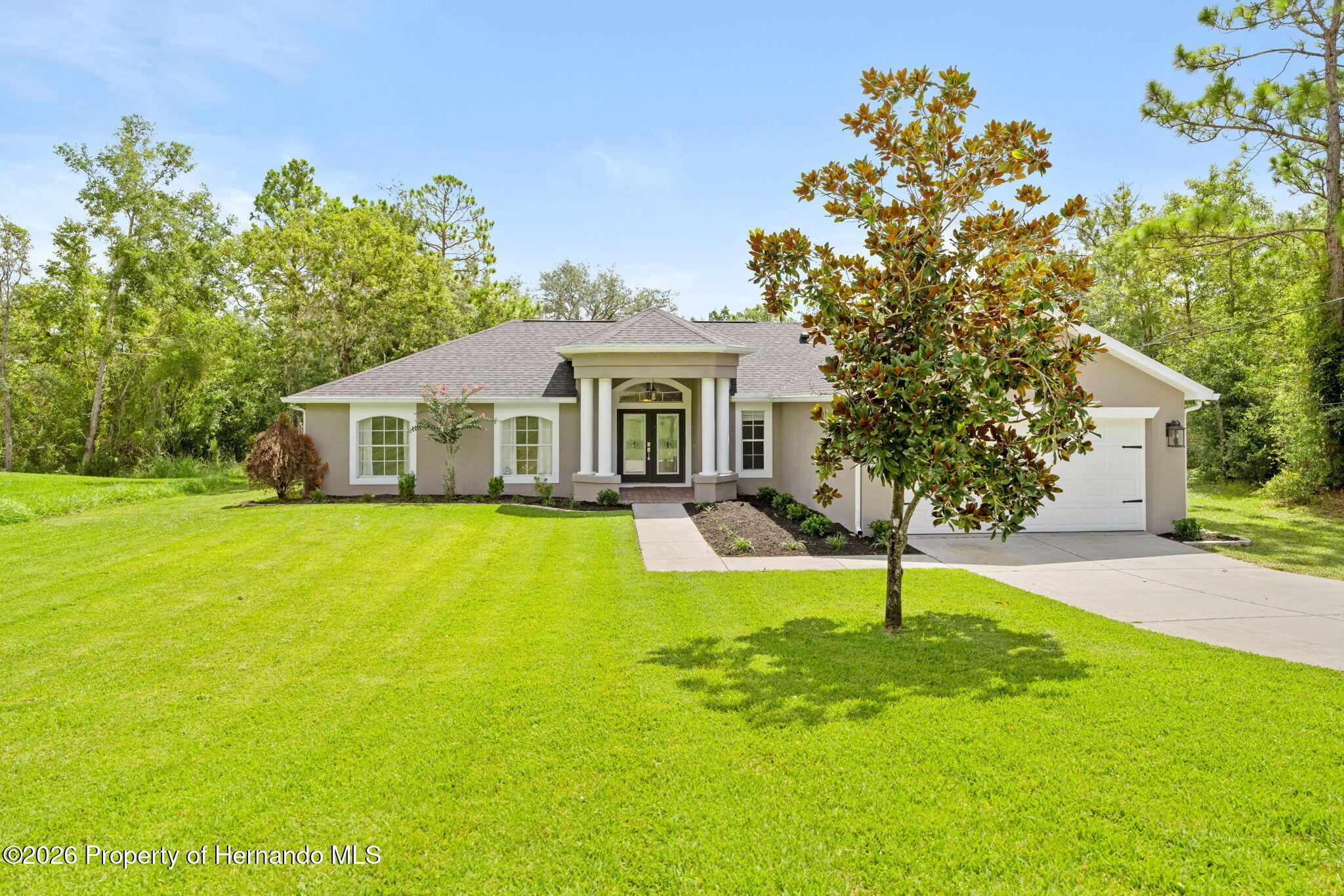 a front view of house with yard and swimming pool