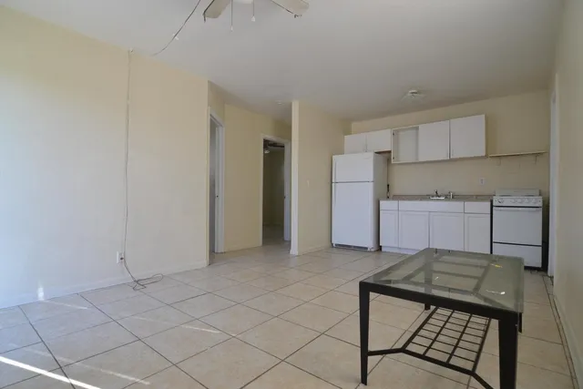 a kitchen with kitchen island cabinets and stove top oven