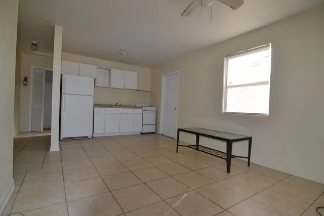 an empty room with closet and windows