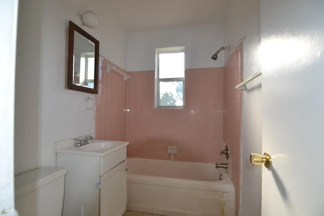 a bathroom with a bathtub a shower and a sink