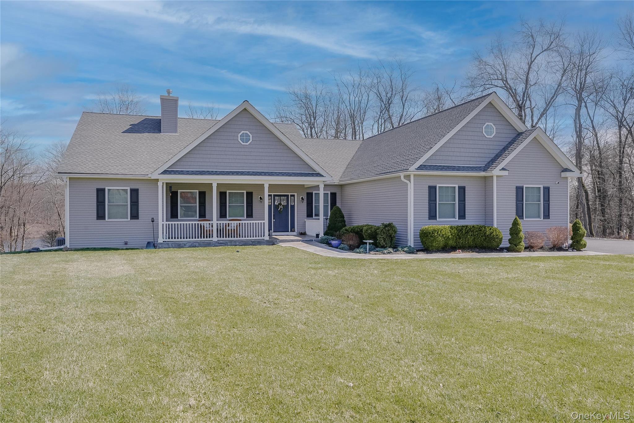 From the moment you arrive, this stunning ranch makes an impression with its elegant bluestone walkway, lush landscaping, and inviting front porch—perfect for relaxing and enjoying the peaceful surroundings. The home’s classic design and refined details offer timeless curb appeal in a serene setting.