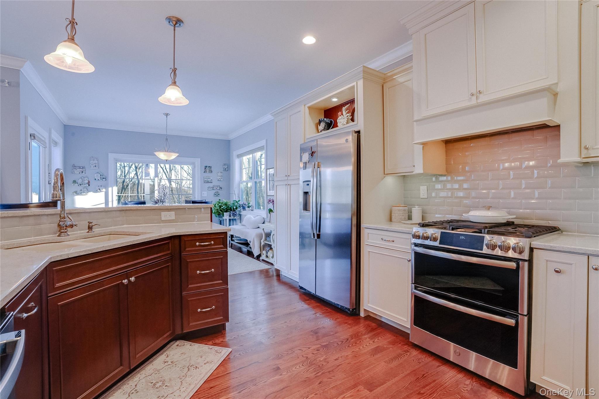 23 Swan Holw Road New Windsor, NY 12553 - Photo 11 of 28 A custom chef’s kitchen features two-tone cabinetry and stainless-steel appliances, offering both style and functionality.