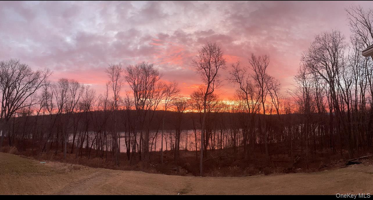 23 Swan Holw Road New Windsor, NY 12553 - Photo 2 of 28 Experience captivating sunset views over the water from the back of the property, offering a truly serene and ever-changing natural backdrop.