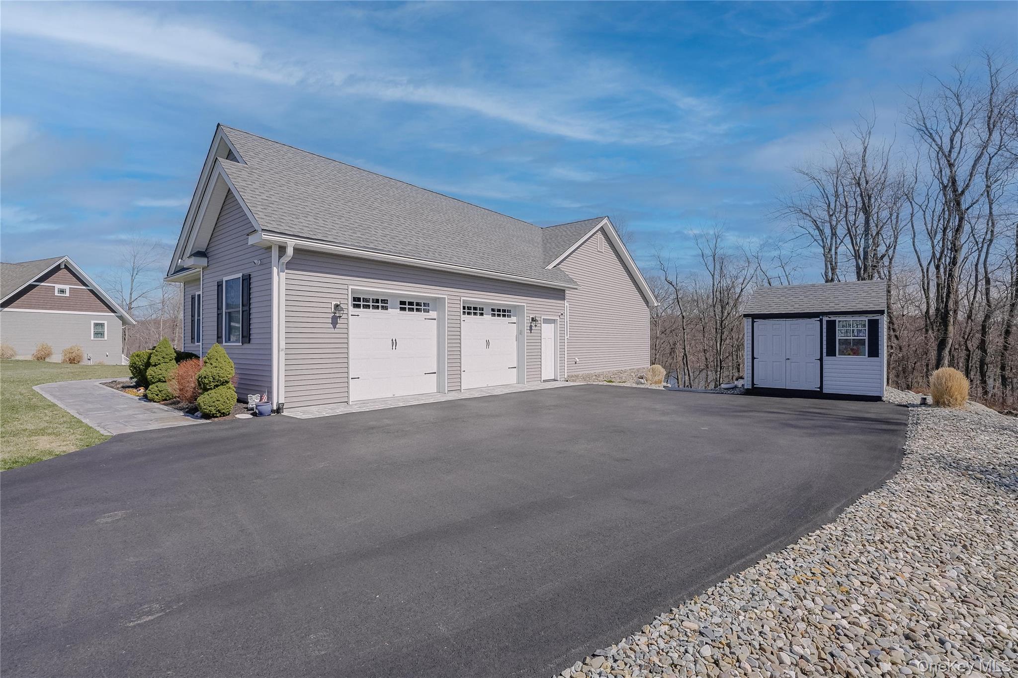 23 Swan Holw Road New Windsor, NY 12553 - Photo 25 of 28 The side of the property offers a spacious two-car garage along with a separate shed, providing ample storage and convenience.