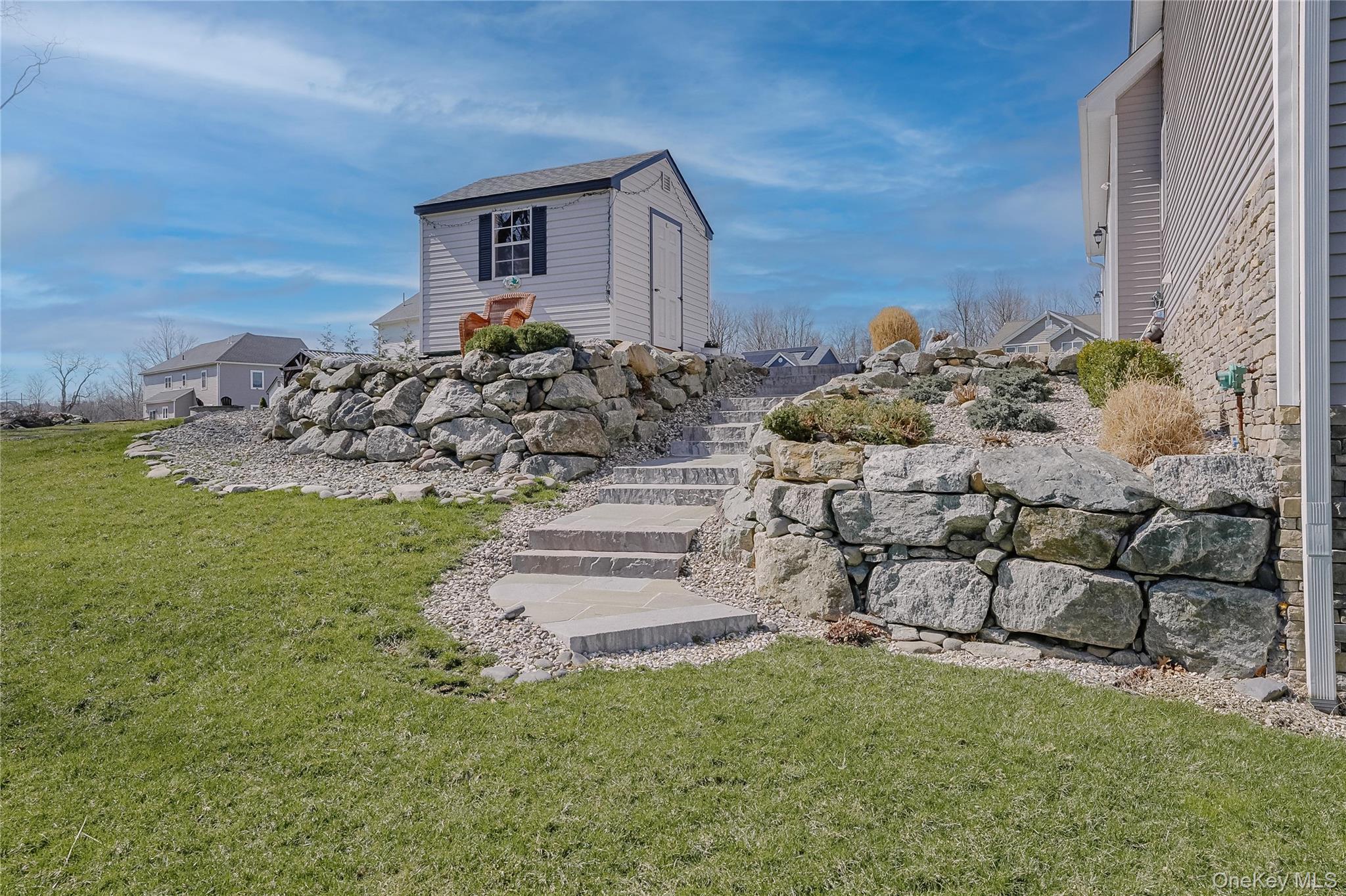 23 Swan Holw Road New Windsor, NY 12553 - Photo 26 of 28 Thoughtfully designed stone steps lead from the backyard to the garage and shed, adding both charm and convenience.