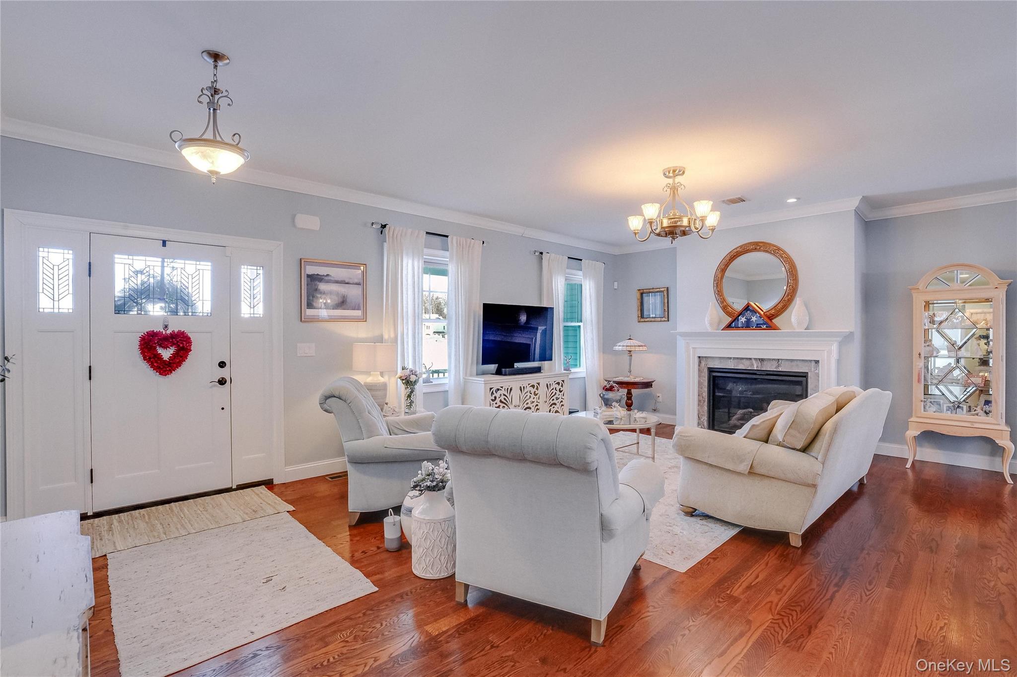 23 Swan Holw Road New Windsor, NY 12553 - Photo 5 of 28 tep into a bright, open entryway that flows effortlessly into the living room, featuring gorgeous hardwood floors and a striking stained-glass door that adds character and charm.