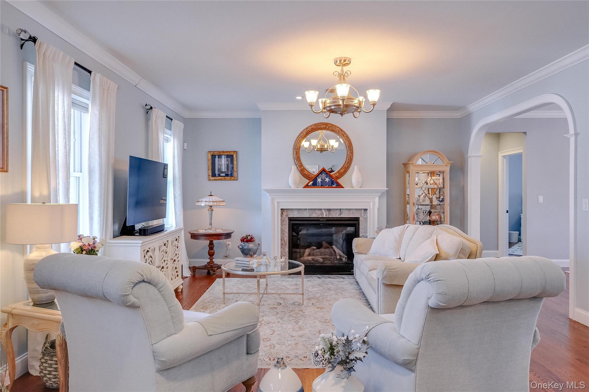 23 Swan Holw Road New Windsor, NY 12553 - Photo 6 of 28 Stunning living room with fireplace, hardwood floors, and elegant trim details.