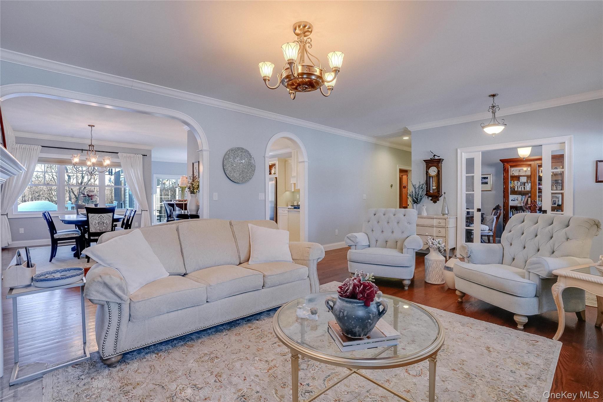 23 Swan Holw Road New Windsor, NY 12553 - Photo 7 of 28 The inviting living room offers the perfect blend of comfort and style, highlighted by a cozy fireplace, beautiful hardwood floors, and intricate trim work that adds a touch of sophistication.