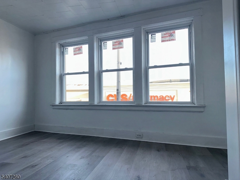 336 Broad Street, Unit 2 Bloomfield, NJ 07003 - Photo 13 of 24 an empty room with wooden floor and windows
