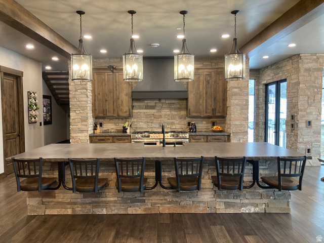 259 Meadow Drive Springville, UT 84663 - Photo 11 of 62 Kitchen with a kitchen bar, a large island with sink, dark wood-type flooring, and wood finish cabinets
