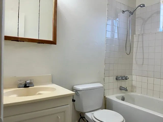 a bathroom with a sink a toilet and bathtub
