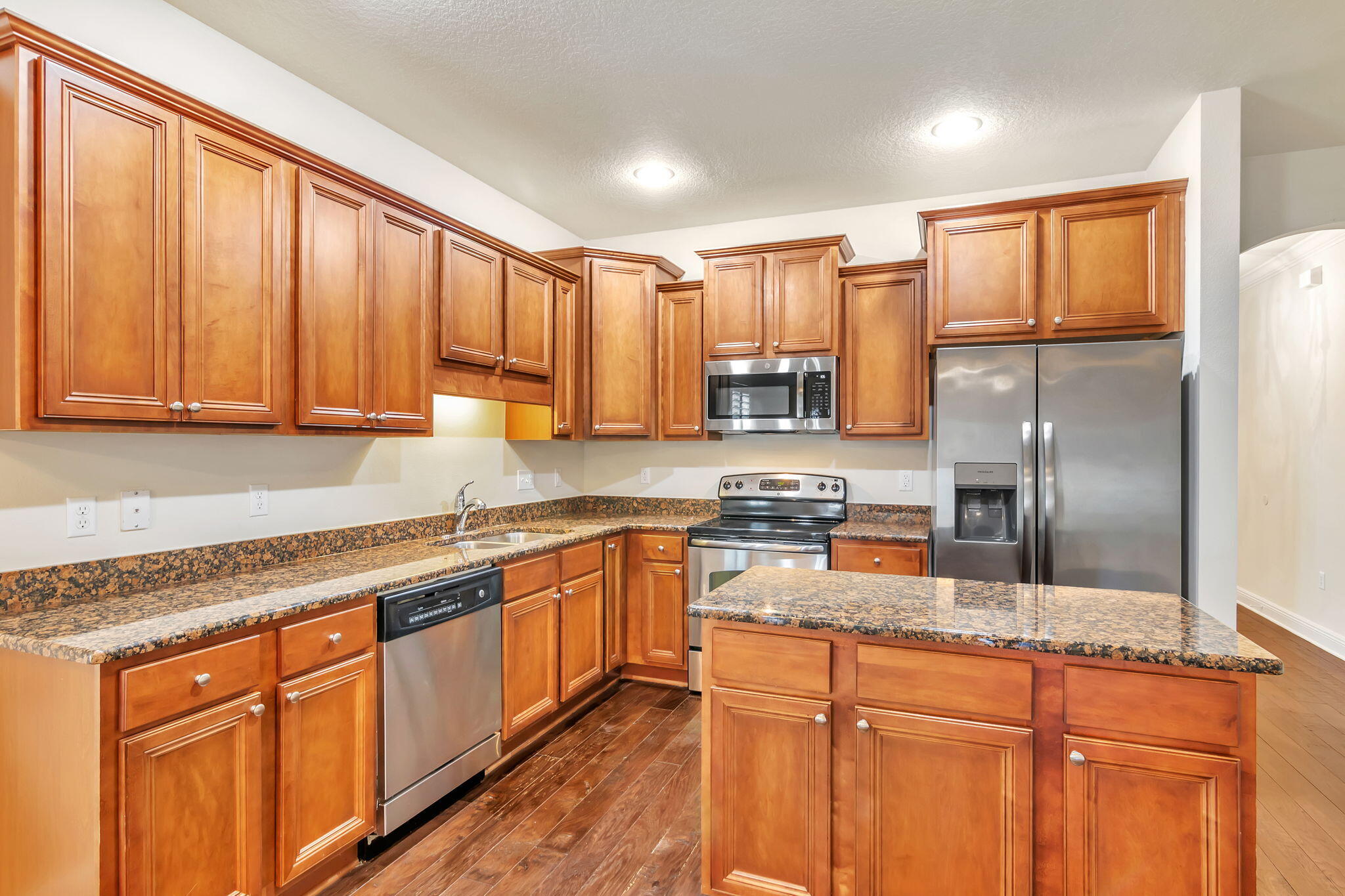 256 Cocobolo Drive Santa Rosa Beach, FL 32459 - Photo 11 of 45 a kitchen with stainless steel appliances granite countertop a refrigerator a sink dishwasher a stove with wooden cabinets and floor