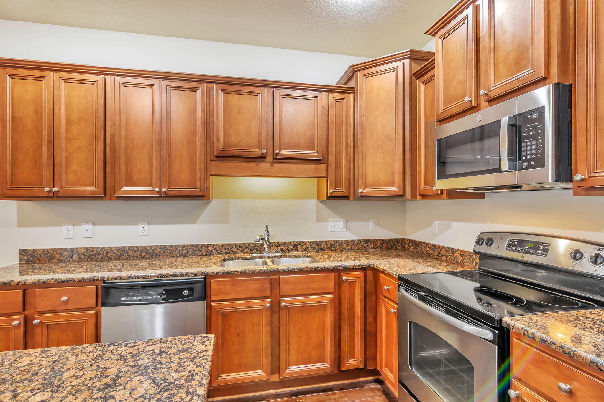 256 Cocobolo Drive Santa Rosa Beach, FL 32459 - Photo 12 of 45 a kitchen with stainless steel appliances granite countertop a stove a sink and a microwave