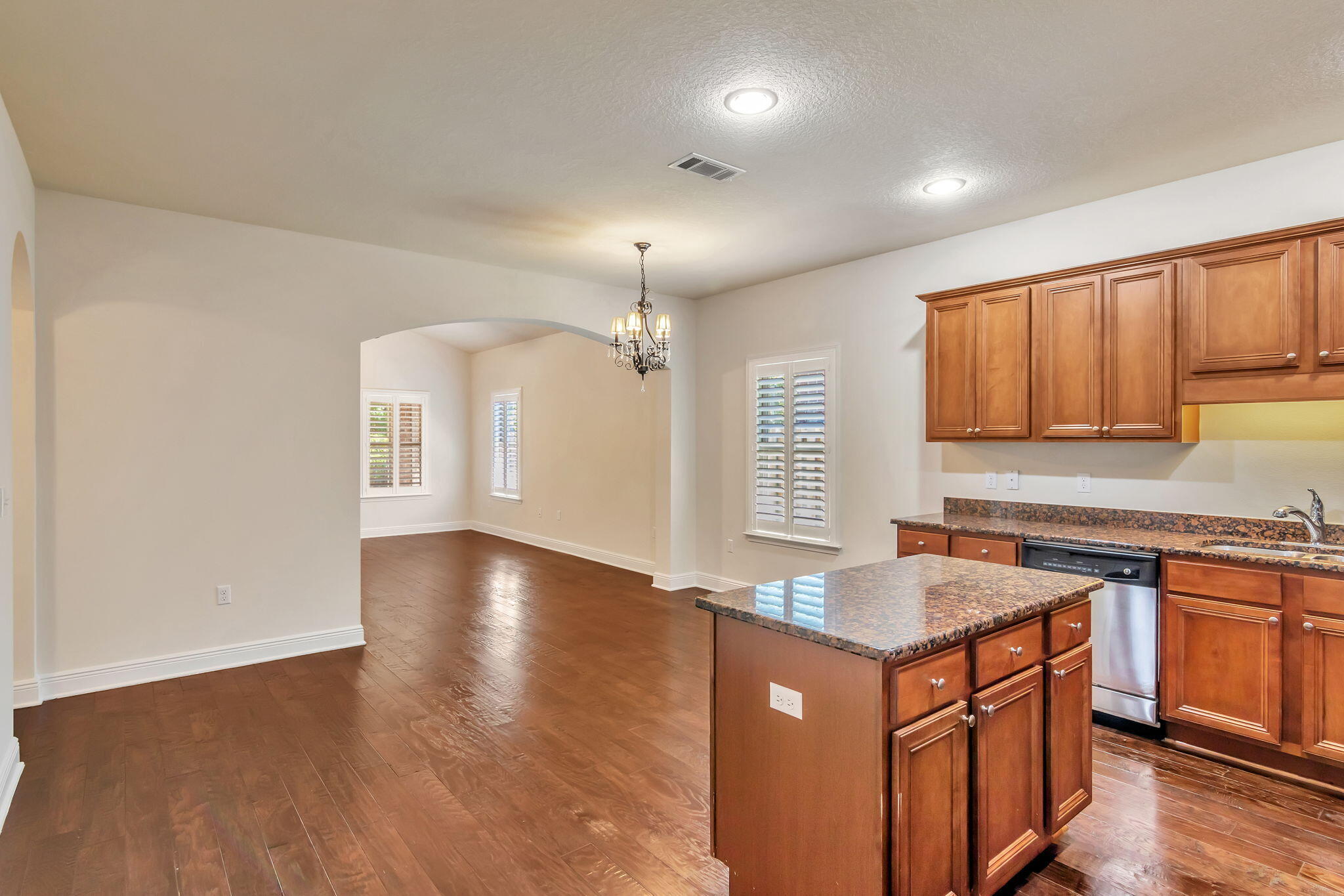 256 Cocobolo Drive Santa Rosa Beach, FL 32459 - Photo 14 of 45 a kitchen with stainless steel appliances granite countertop a sink a stove a refrigerator and island with wooden floor