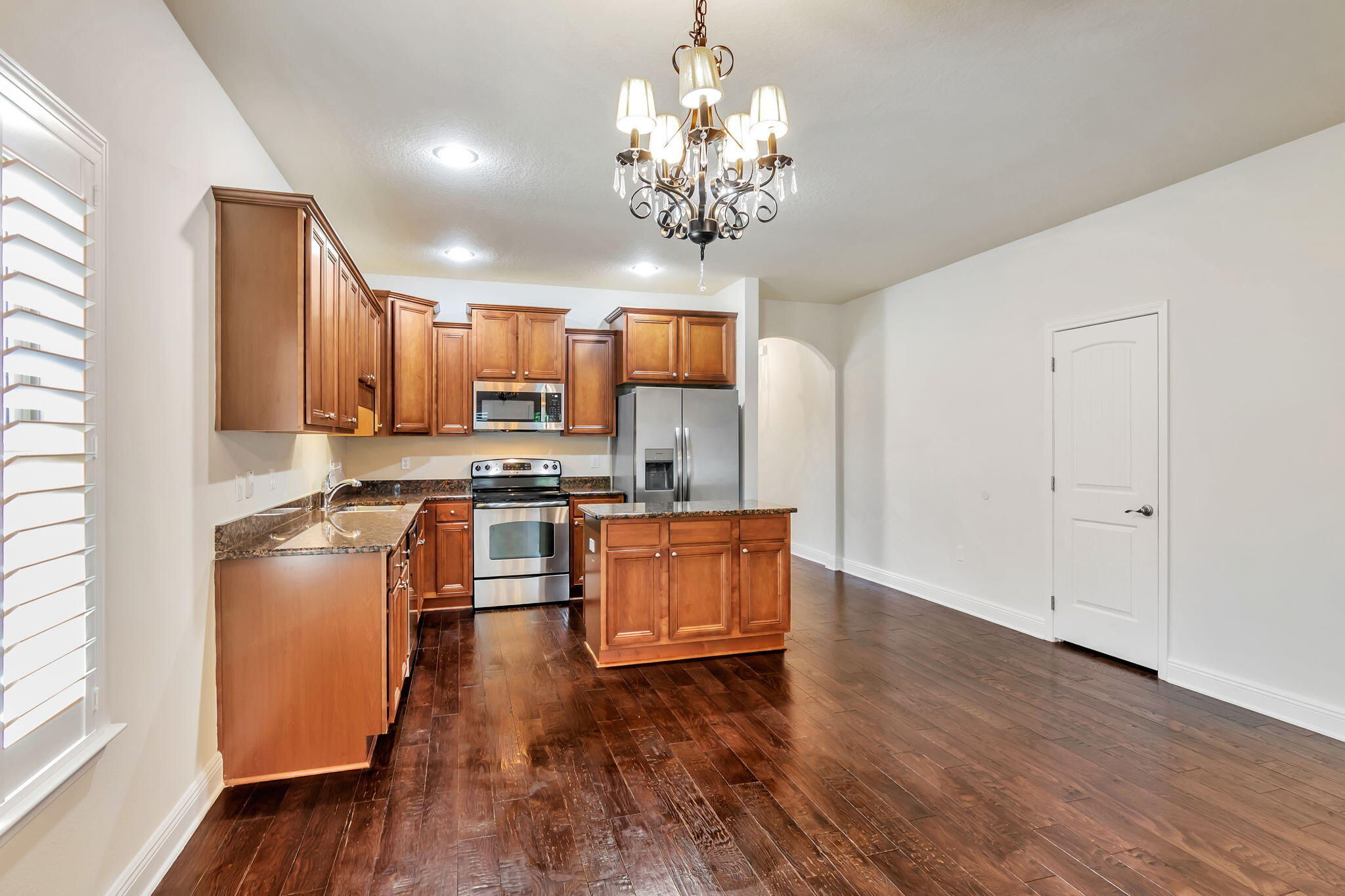 256 Cocobolo Drive Santa Rosa Beach, FL 32459 - Photo 16 of 45 a kitchen with stainless steel appliances granite countertop a refrigerator stove a sink dishwasher and wooden cabinets with wooden floor