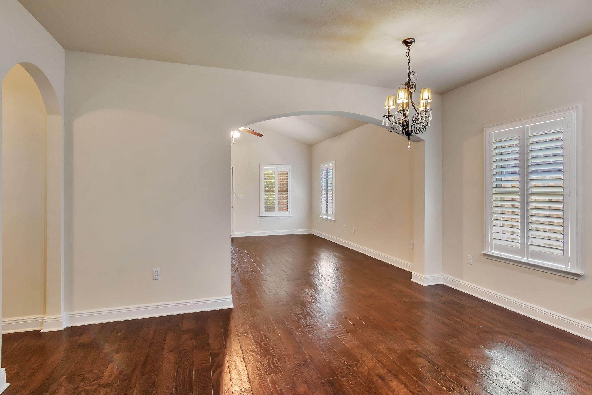 256 Cocobolo Drive Santa Rosa Beach, FL 32459 - Photo 20 of 45 a view of empty room with wooden floor chandelier and window