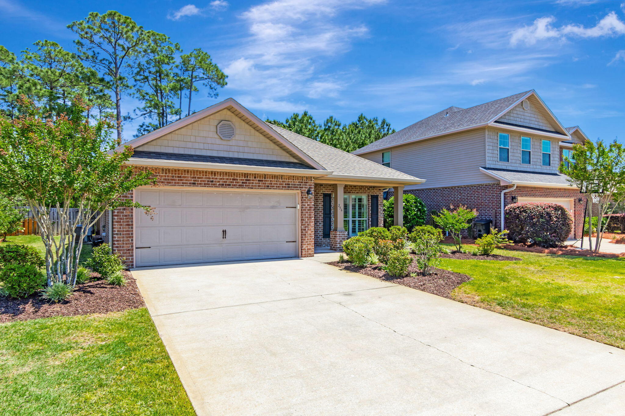256 Cocobolo Drive Santa Rosa Beach, FL 32459 - Photo 3 of 45 a front view of a house with a yard and garage