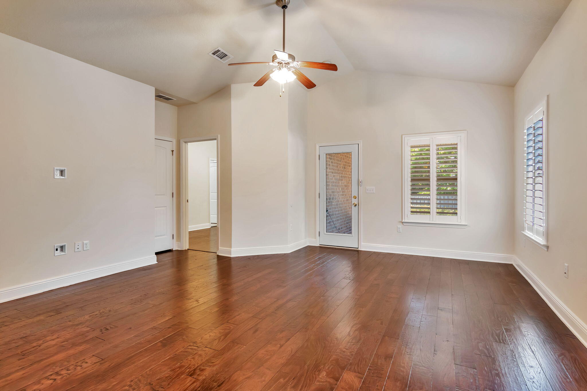 256 Cocobolo Drive Santa Rosa Beach, FL 32459 - Photo 7 of 45 a view of an empty room with wooden floor and a window
