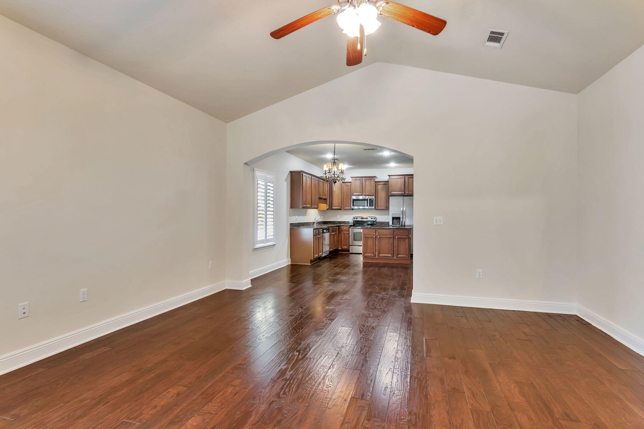 256 Cocobolo Drive Santa Rosa Beach, FL 32459 - Photo 9 of 45 a view of a livingroom with wooden floor a ceiling fan and kitchen