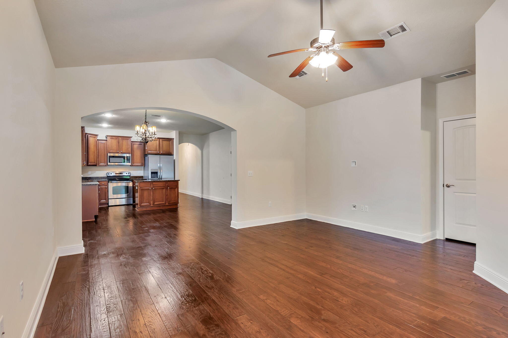 256 Cocobolo Drive Santa Rosa Beach, FL 32459 - Photo 10 of 45 a view of a room with wooden floor a ceiling fan and windows