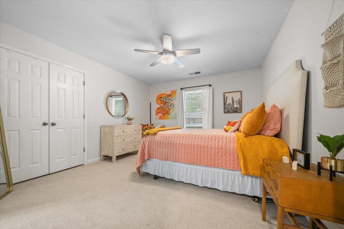 1876 Liles Lane Collierville, TN 38017 - Photo 19 of 36 Carpeted room featuring a ceiling fan with integrated lighting, a window with blinds, and a double-door closet with paneling