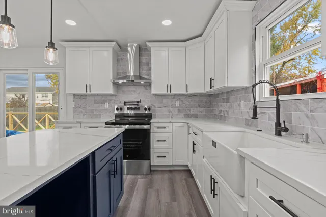 a kitchen with granite countertop a sink stainless steel appliances and cabinets