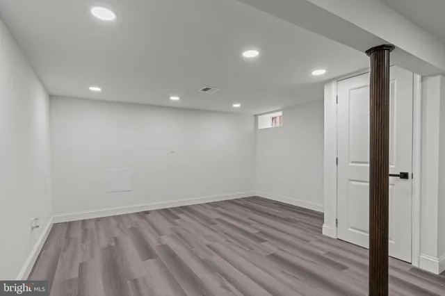 a view of room with wooden floor