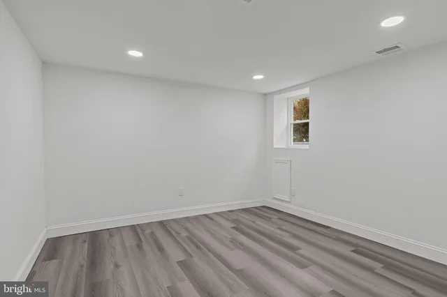 a view of room with wooden floor and window