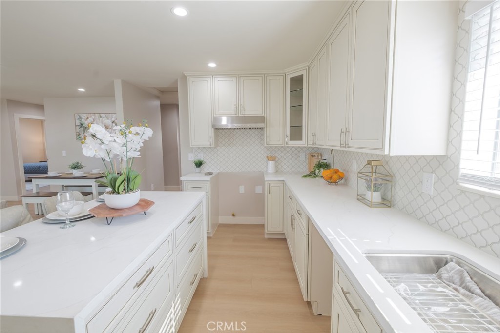 223 South Aprilia Avenue Compton, CA 90220 - Photo 8 of 46 a kitchen with a sink stove and cabinets