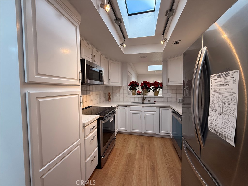 1921 St John Road, Unit 35C Seal Beach, CA 90740 - Photo 12 of 40 a kitchen with stainless steel appliances a refrigerator sink and stove