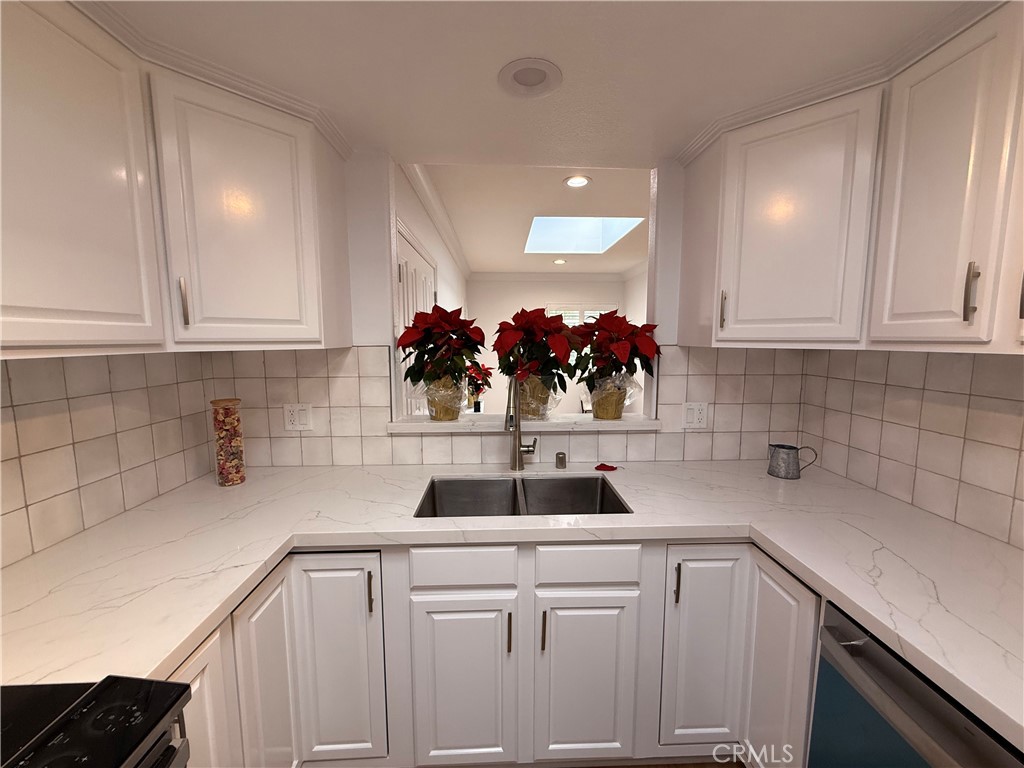 1921 St John Road, Unit 35C Seal Beach, CA 90740 - Photo 16 of 40 a view of a kitchen with sink and cabinets