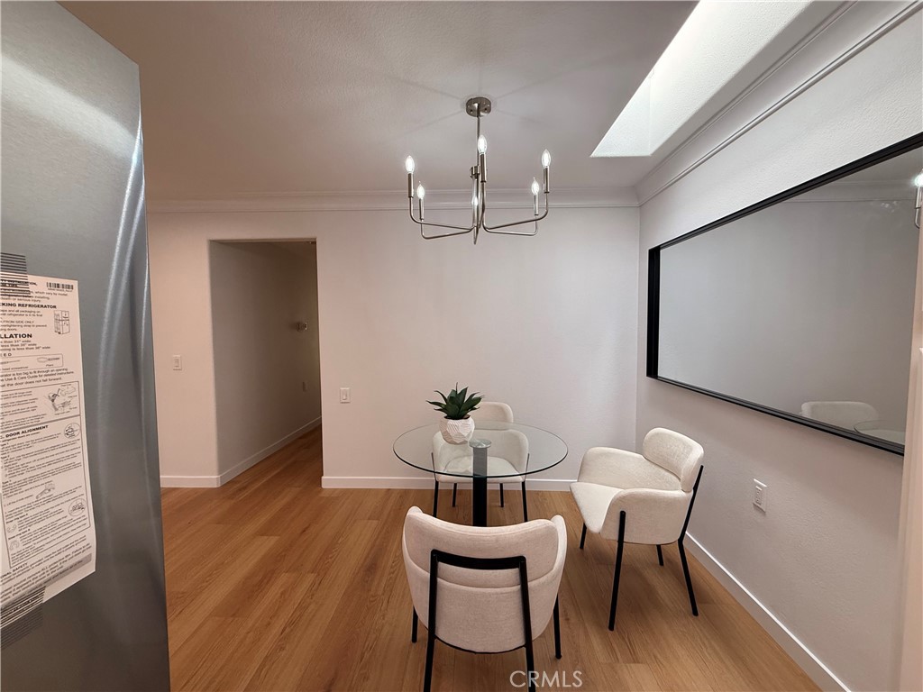 1921 St John Road, Unit 35C Seal Beach, CA 90740 - Photo 17 of 40 a view of a dining room with furniture and wooden floor